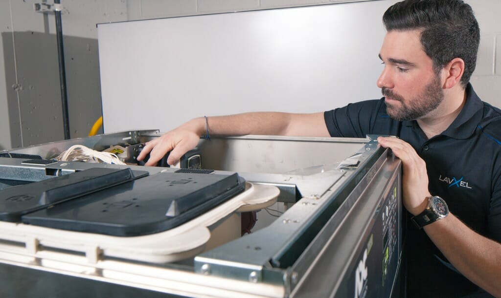 LavXel technician servicing laundry equipment